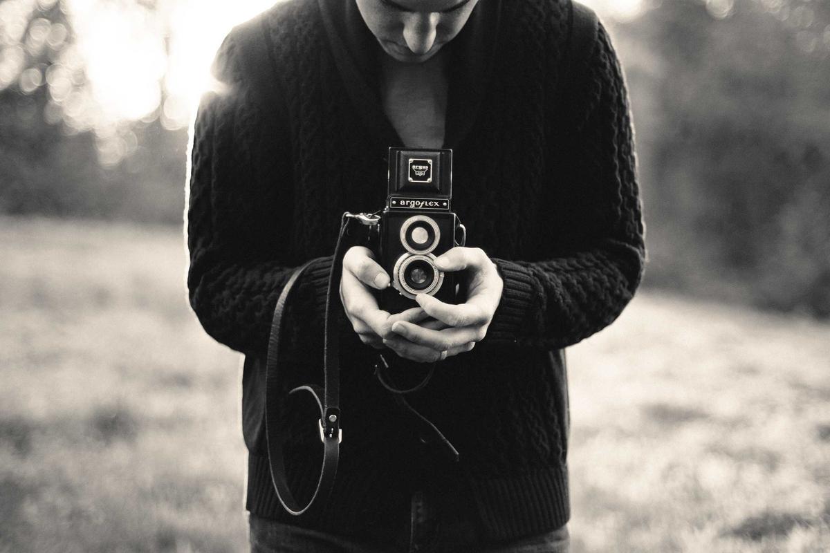 Photographer holding a vintage camera